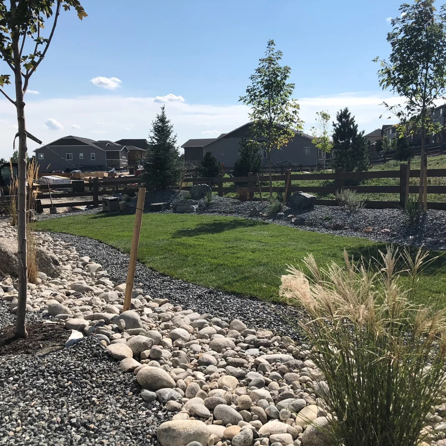 Complete landscape installation — new sod, topsoil, and planting beds a family can actually use.